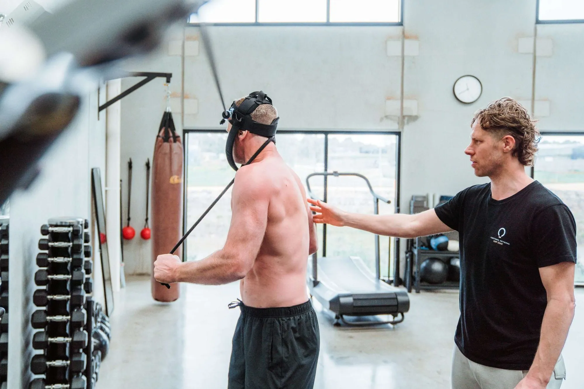 Shane coaching a client through a cable movement