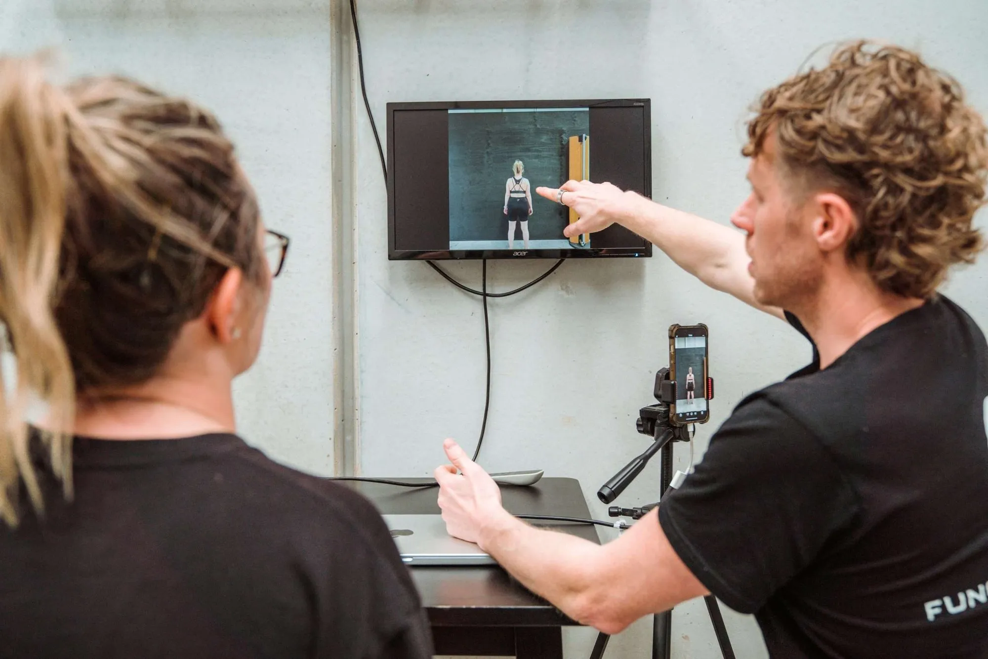 Shane reviewing a client's gait on screen during an assessment