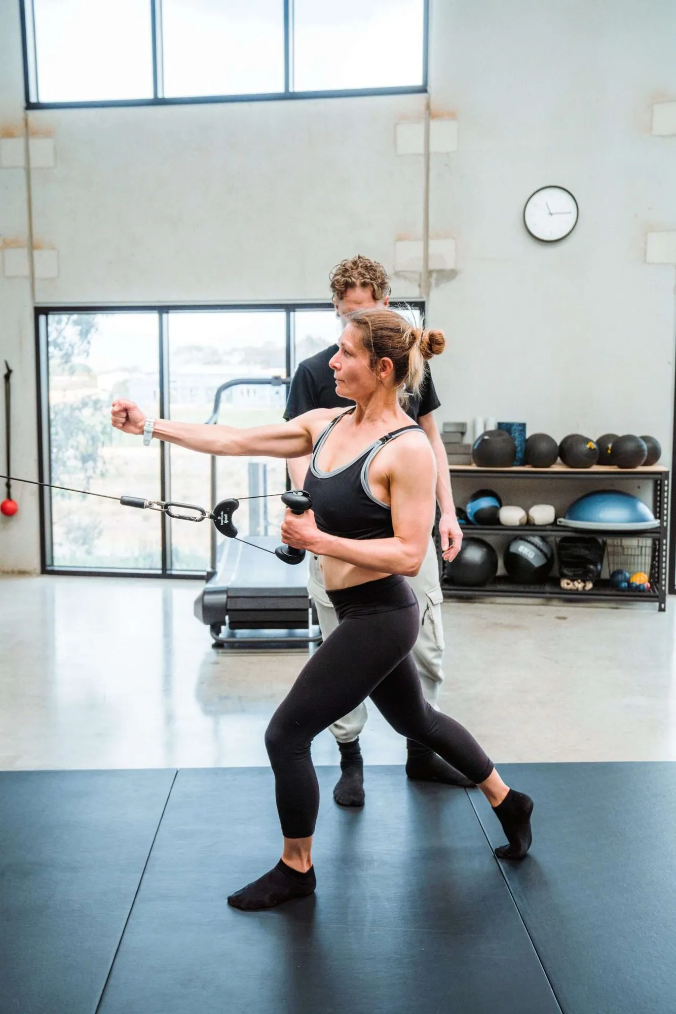 A client training a lunge on the cable machine